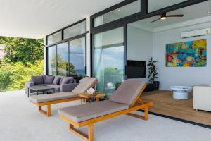 a living room with two chairs and a couch at Shamgrila - Panoramic Sea View in Ko Phangan