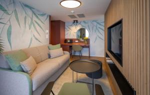 a living room with a couch and a television at Botel Marina in Prague