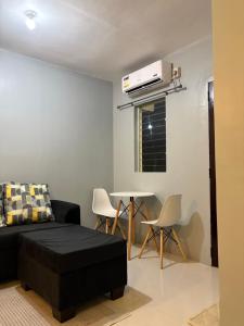a living room with a bed and a table at ALCA Homestay in Palo +1 photo