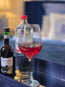 a glass of wine next to a bottle of wine at Midcoast Studio TheBlue in Nortorf