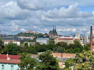 a view of a city with buildings and trees at TUGENDHAT Boutique Suite in Komárov
