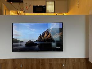 a flat screen tv sitting on a wall at TUGENDHAT Boutique Suite in Komárov