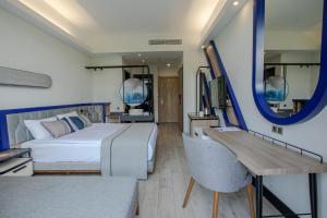 a bedroom with a bed and a desk and a mirror at Armella Hill Hotel in Side +49 photos