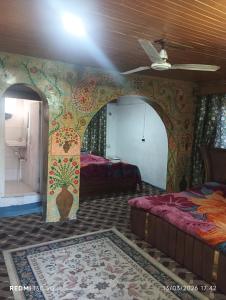 a room with a bed and a wall with a mural at New shalimar dal view in Srinagar +19 photos