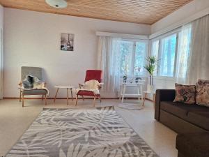 a living room with a couch and chairs and a table at Large detached house without neighbors in Kouvola