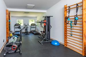 a gym with several treadmills and exercise bikes at Kúpeľný dom GERLACH in Vysoké Tatry