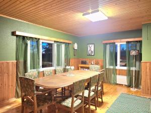 a dining room with a wooden table and chairs at Large detached house without neighbors in Kouvola +16 photos