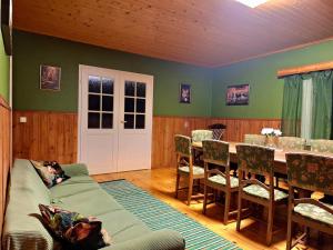 a living room with a couch and a table and chairs at Large detached house without neighbors in Kouvola