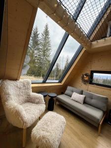 a living room with a couch and a window at Yatak in Vatra Dornei