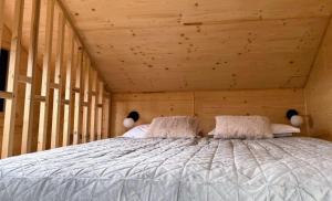 a bedroom with a bed in a wooden room at Yatak in Vatra Dornei