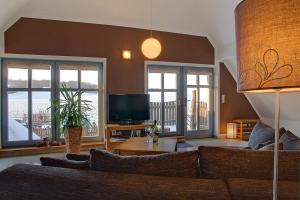a living room with a couch and a tv at Dreiurtshof Fewo 2 in Remplin