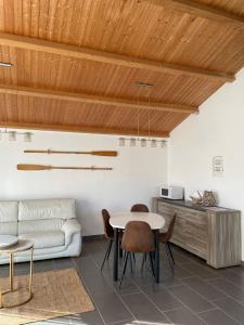 a living room with a couch and a table and chairs at Escapade Maritime in Dompierre-sur-Mer