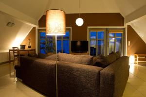 a living room with a couch and a lamp at Dreiurtshof Fewo 2 in Remplin +4 photos