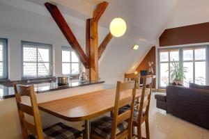 a kitchen and dining room with a wooden table and chairs at Dreiurtshof Fewo 2 in Remplin