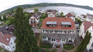 an aerial view of a large house with a lake at Ferienresidenz Seegarten Andrea - Seezugang und Schwimmbad in Bodman-Ludwigshafen
