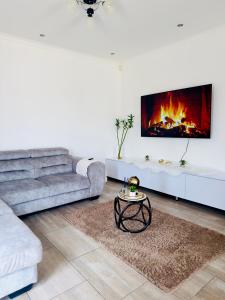 a living room with a couch and a fireplace at Immari stays in Swakopmund