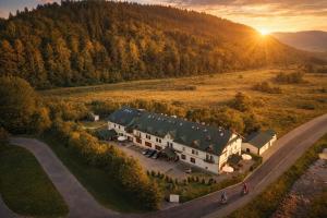 an aerial view of a large house with a road at Piastun SPA&Wellness Krynica-Zdrój in Krynica Zdrój