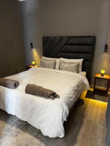 a bedroom with a large bed with white sheets and pillows at Immari stays in Swakopmund