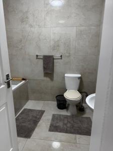 a bathroom with a toilet and a sink at Immari stays in Swakopmund +6 photos