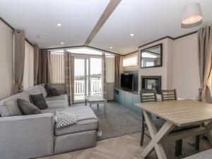 a living room with a couch and a table at Plot 243 - Coldingham Bay Leisure Park in Eyemouth