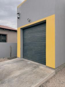 a pair of garage doors on a building at Immari stays in Swakopmund