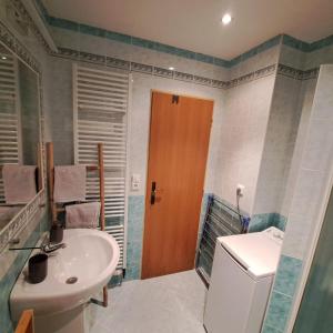 a bathroom with a sink and a toilet and a mirror at Apartmán Ševcovská in Zlín +30 photos