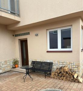 a bench and a table in front of a building at Apartmán Ševcovská in Zlín