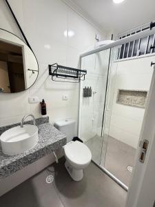 a bathroom with a toilet and a sink and a shower at Villa Catarina in Guarulhos