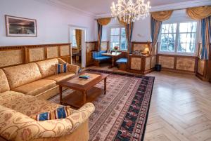a living room with a couch and a table at Schloss Hotel Wasserburg in Wasserburg +44 photos