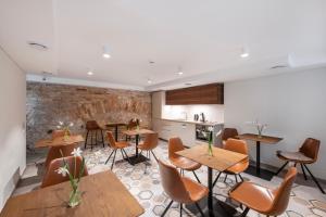 a restaurant with tables and chairs and a kitchen at GRAND CROWN in Vilnius