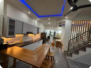a kitchen with a wooden table in a room at Villa Manis in Denpasar