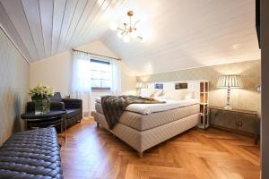 a bedroom with a large bed and a couch at Bottengarn Boutique Guesthouse - Farm in Igaküla +5 photos