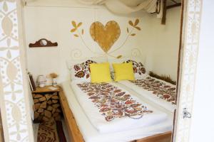 a bedroom with a bed with a heart on the wall at Folklórna chyža in Bojnice