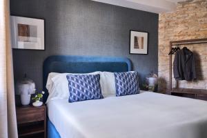 a bed with a blue headboard in a bedroom at Seda Residences in Granada