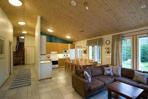 a large living room with a couch and a kitchen at PUUSTILANRANTA 4 A (5 mh) in Tahkovuori