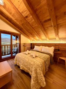 a bedroom with a large bed with a wooden ceiling at APARTAMENTOS EL CORITU, estrenamos dos apartamentos, el 4 y 5 in Nieda