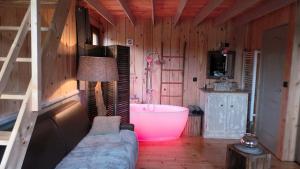 a living room with a bath tub and a couch at Cabanes flottantes et gîtes au fil de l'eau in Colleville +115 photos