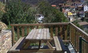 a wooden bench sitting on top of a balcony at Casa do Padrinho in Teixeira de Baixo +11 photos