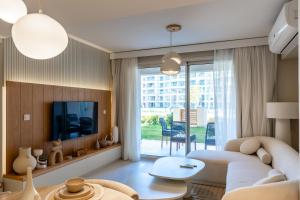 a living room with a couch and a tv at BirdNest Vacation homes at Marassi marina in El Alamein