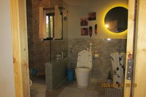 a bathroom with a toilet and a shower at BIG J'S Farm House in Dhulikhel +41 photos