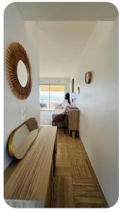 a living room with a large mirror on the wall at Casa Monica Nizza VILLENEUVE-LOUBET in La Celle-sous-Gouzon