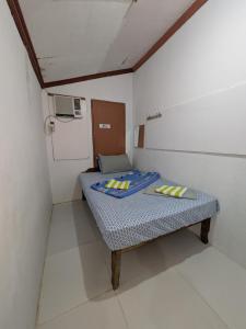 a small room with a small bed in it at Rubilla's Homestay and Motor Rental in Mambajao