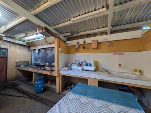 a kitchen with a sink and a counter top at Rubilla's Homestay and Motor Rental in Mambajao +86 photos