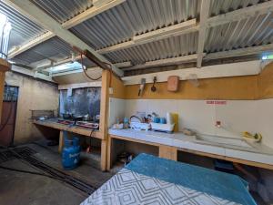 a kitchen with a counter and a sink in a room at Rubilla's Homestay and Motor Rental in Mambajao