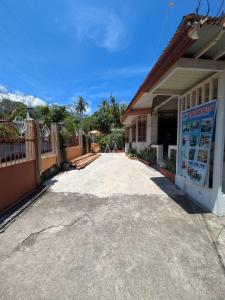 a parking lot outside of a building at Rubilla's Homestay and Motor Rental in Mambajao