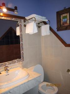 a bathroom with a sink and a tub and a toilet at Hostal Rural Jarpar in Grajera