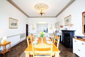 a kitchen and dining room with a table and chairs at Riversdale in Falmouth +11 photos