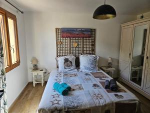 a bedroom with a large bed with blue pillows at le balcon du Canigo' in Escaro