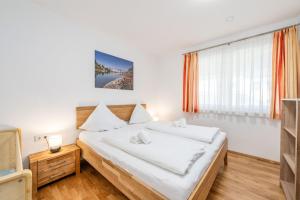 a bedroom with two beds and a television at Appartement Franz Josef - by myNests in Aich