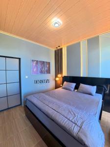 a bedroom with a large bed in a room at Denis cozy homestay in Senaru
